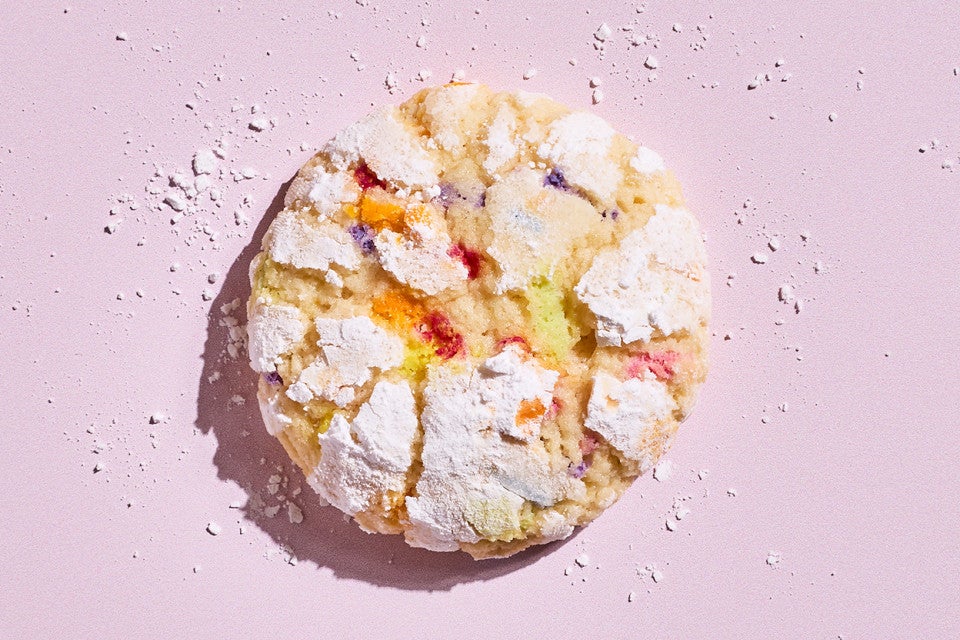 A Sprinkle Crinkle Cookie on a light lavender background