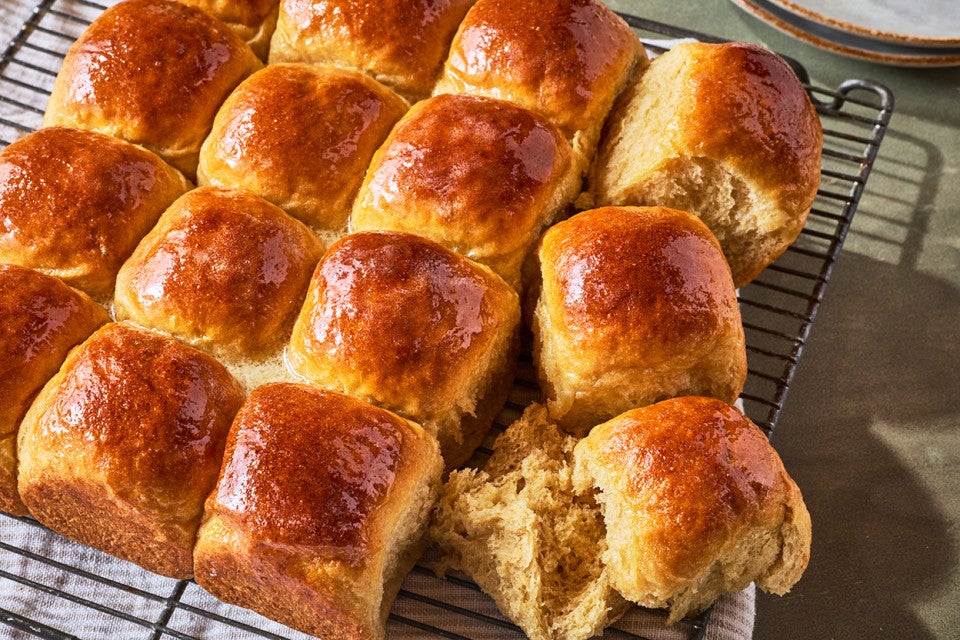 Whole Wheat Dinner Rolls on a cooling rack