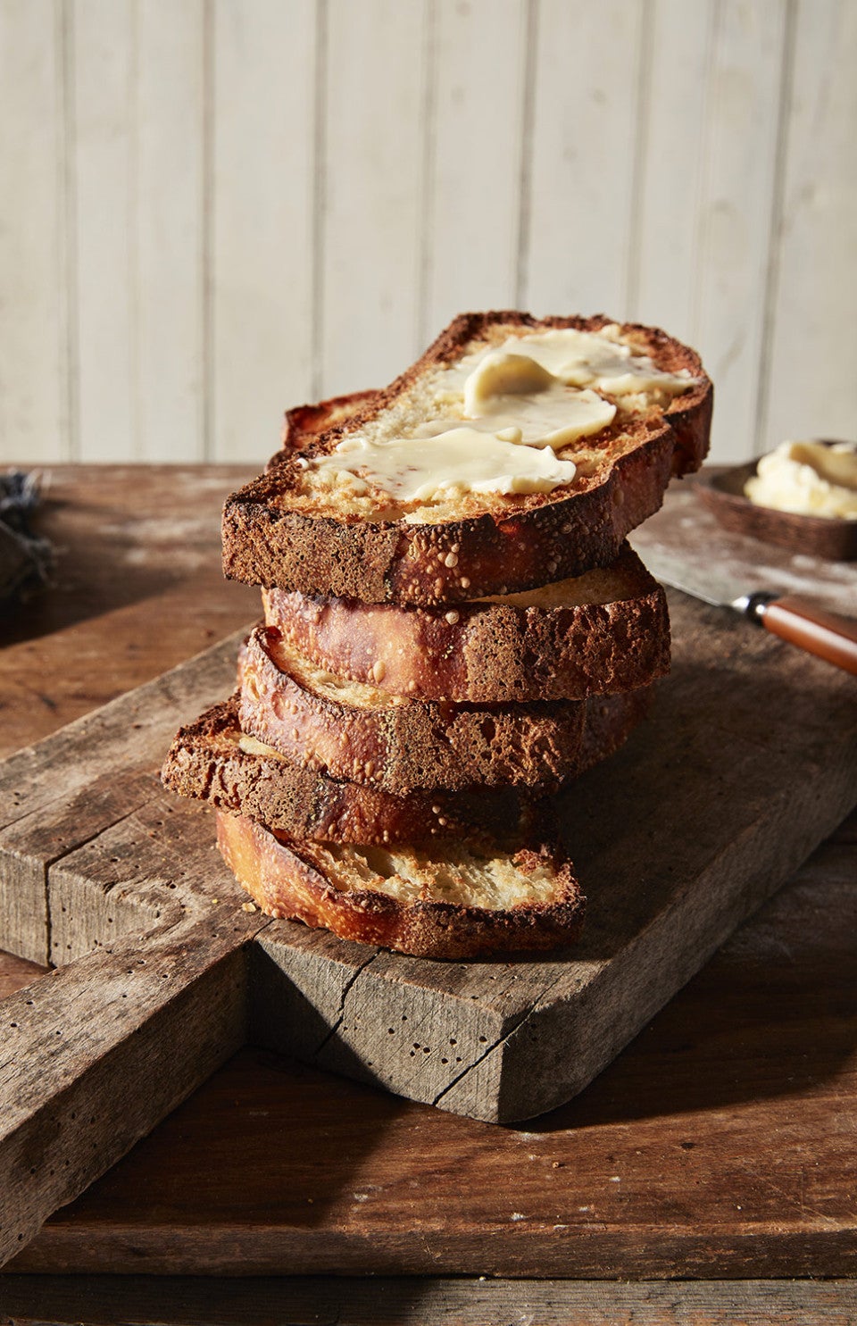 Absolutely No-Knead Crusty White Bread sliced and stacked on a cutting board