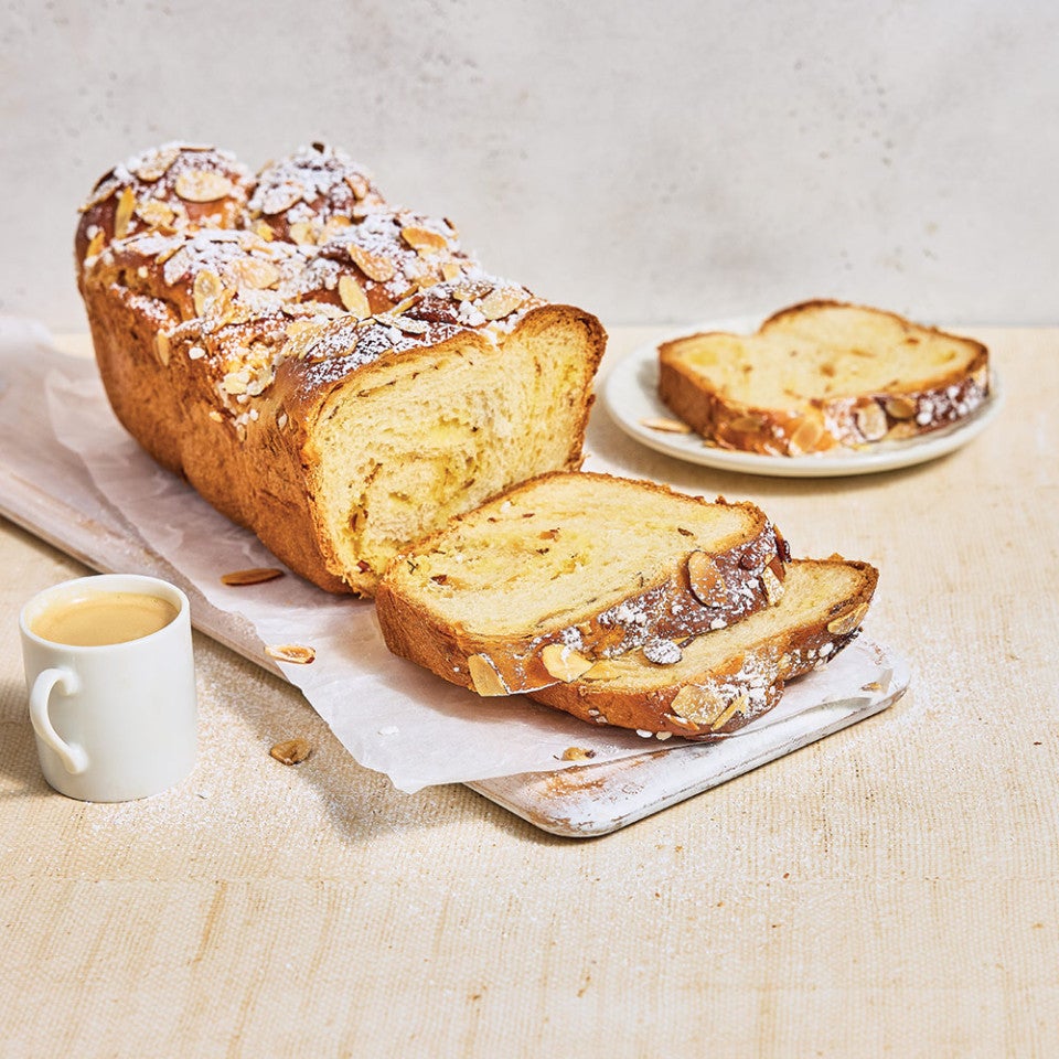 Almond Croissant Milk Bread sliced on a cutting board
