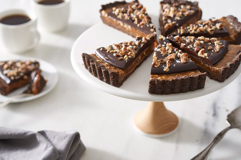 Salted Caramel Chocolate Tart on a pedestal