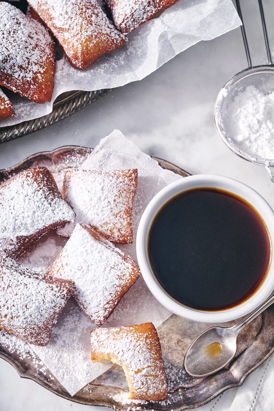 Classic Beignets on a plate with a cup of coffee