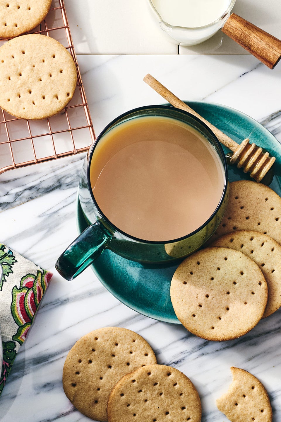 Digestive Tea Biscuits arranged on a marble with a cup of tea
