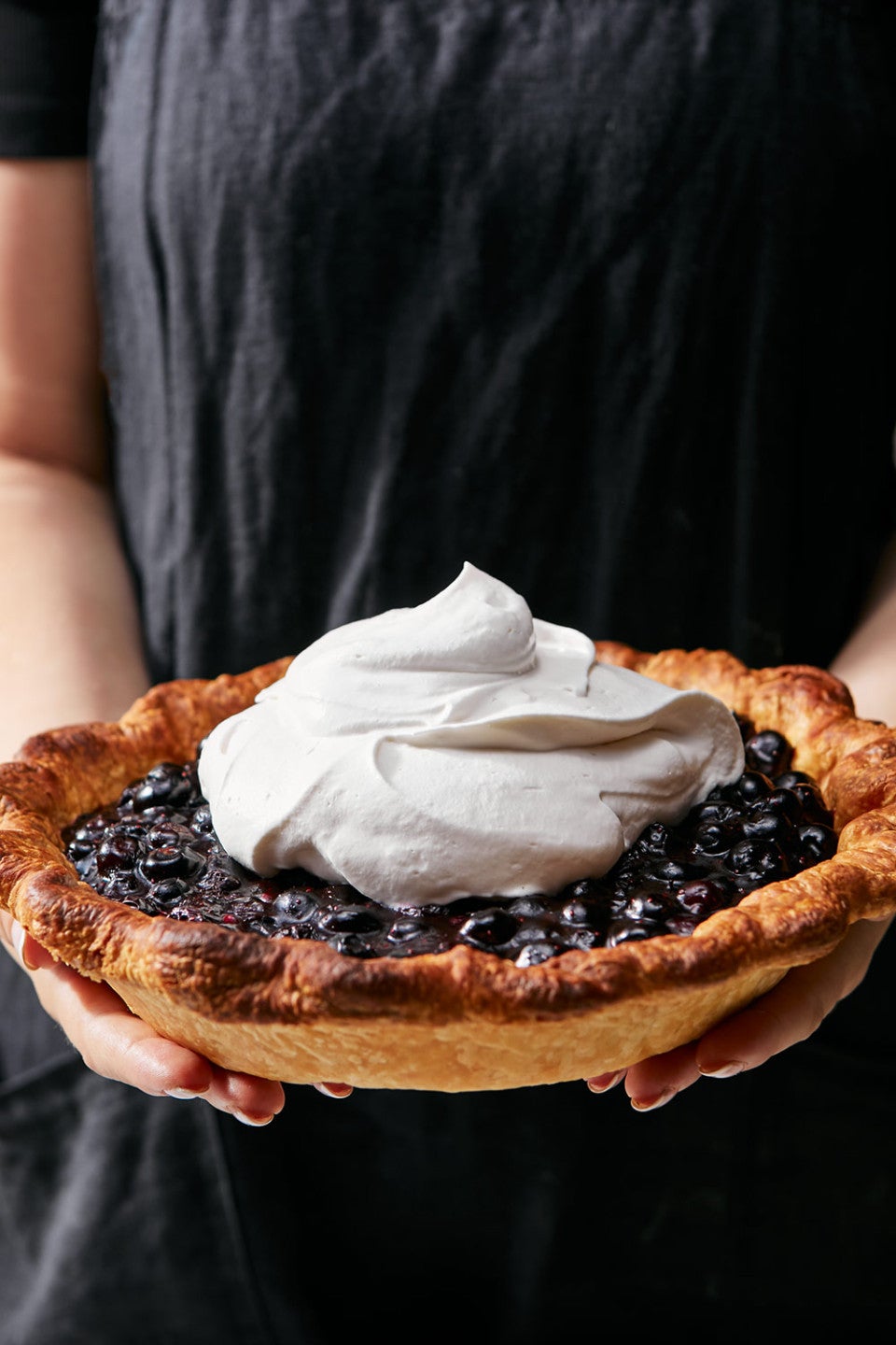 Holding fresh blueberry pie