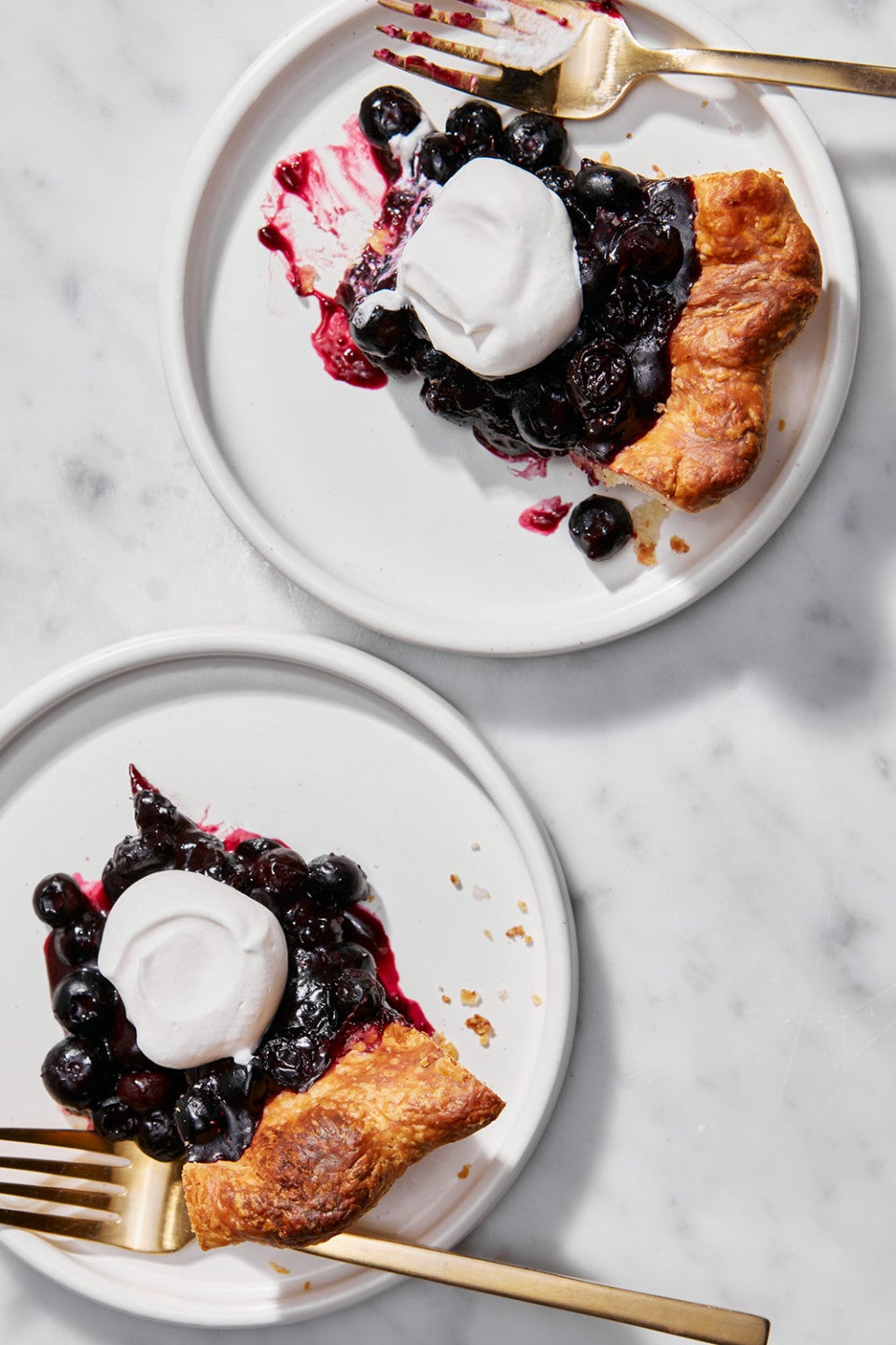 Slices of Fresh Blueberry Pie on plates seen from above