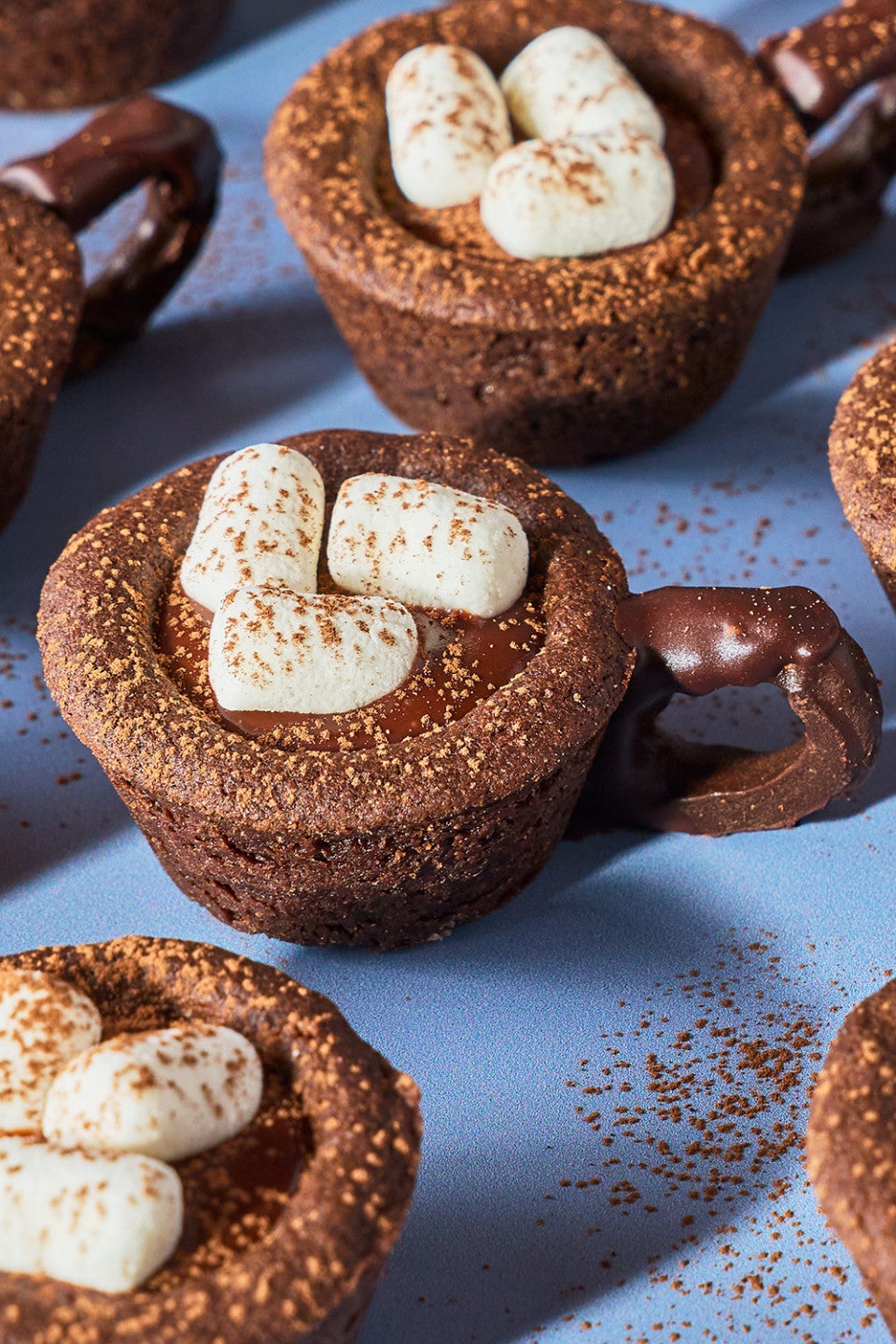 Hot Cocoa Cookies arranged on a blue surface