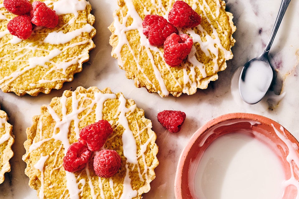 Mini Almond Tarts seen from above with glaze in a bowl and on a spoon