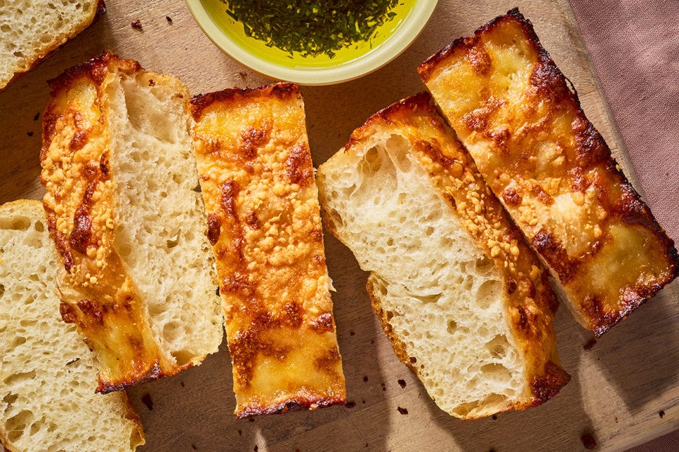 Small-Batch Cheesy Focaccia sliced on a cutting board