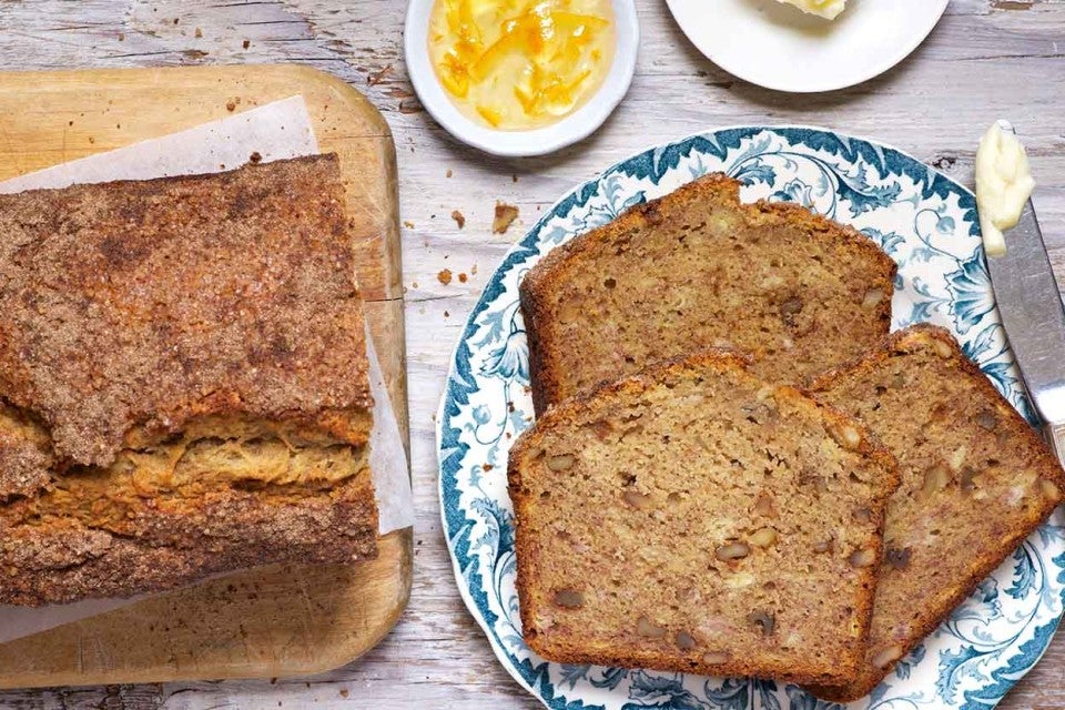A few slices of Whole Wheat Banana Bread next to the full loaf. 
