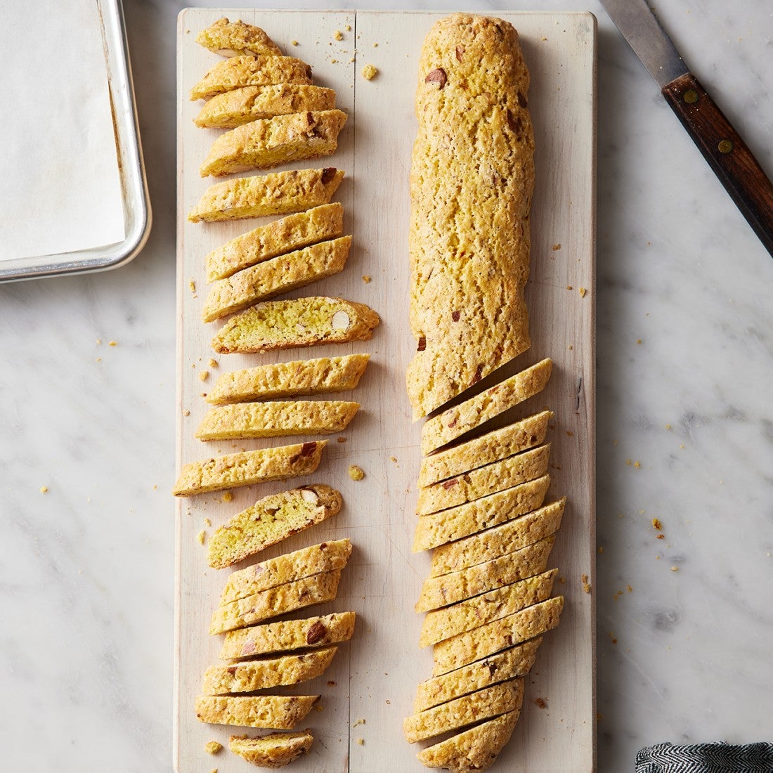 Biscotti being sliced for its second bake
