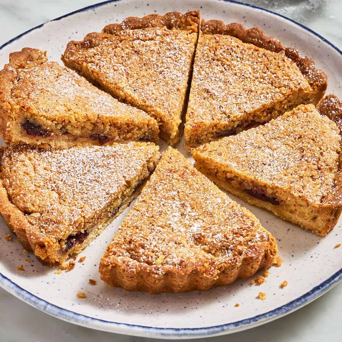 Pecan Cherry Bourbon Tart sliced on a plate seen from above