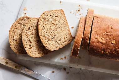 A loaf of malted wheat bread cut into slices