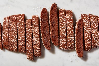 Chocolate brownie biscotti cut into slices, topped with pearl sugar