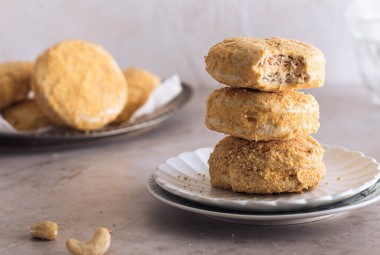 A stack of Filipino cookies, made with buttercream sandwiched between two cashew-meringue wafers coated with cookie crumbs