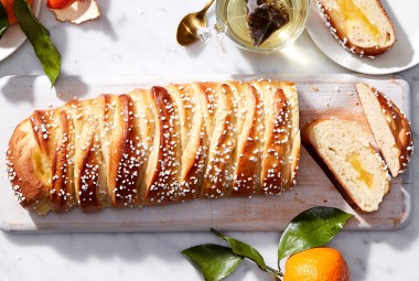 A loaf of braided bread filled with lemon curd and cut into slices
