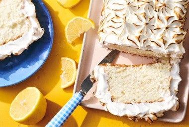 Lemon Angel Food Cake with Meringue Topping sliced on a serving tray
