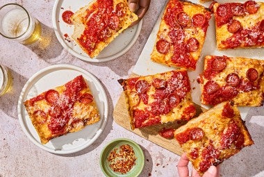 Slices of Weeknight Detroit Pizza on a table, shown from above.