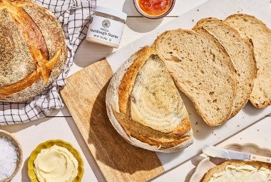 Naturally Leavened Sourdough Bread sliced on a cutting board seen from above.