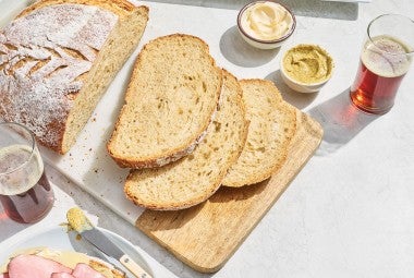 Sourdough Beer Bread sliced on a cutting board.