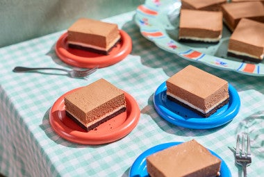 No-Bake Chocolate Cheesecake Bars arranged on a table