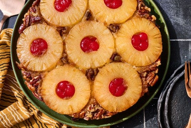 Pineapple Upside Down Cake seen from above with caremelized pineapple rings filled with maraschino cherries