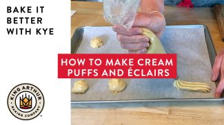 Piping pâte à choux onto a baking sheet for éclairs