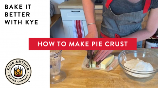Hands cutting butter for pie crust