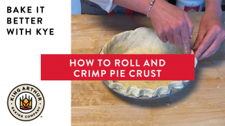 Hands crimping pie crust in a pie plate
