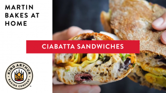 Hands holding ciabatta sandwiches 