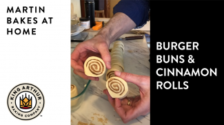 Hands holding sliced unbaked cinnamon rolls 
