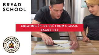 Martin and Arlo scoring bread dough with scissors