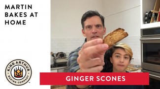 Martin and Arlo holding up scone in kitchen with text overlay of video title